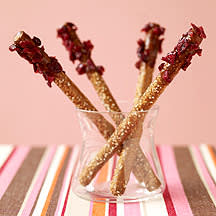 Photo of Dipped pretzel rods with chocolate, caramel-pecans and cranberries by WW