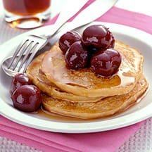 Photo of Oatmeal-buttermilk pancakes topped with cherries by WW