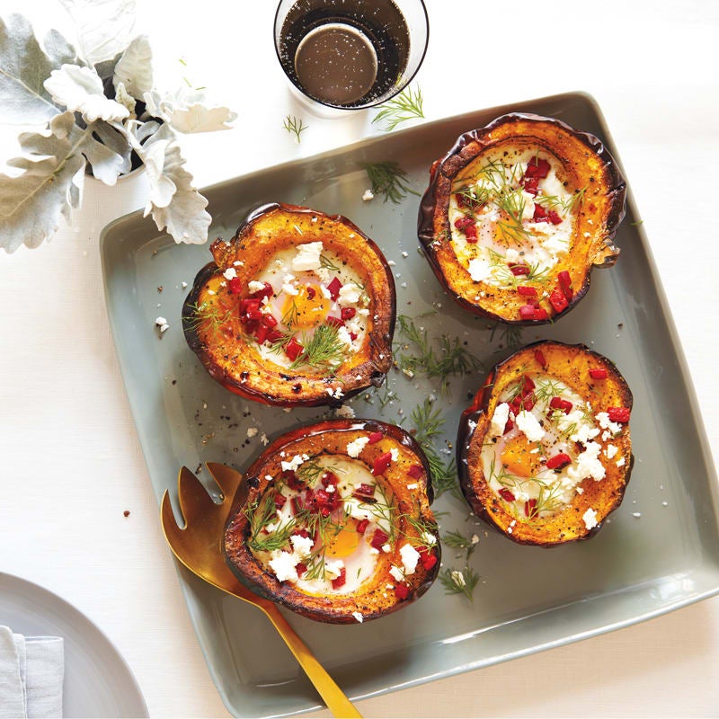 Baked eggs in acorn squash with roasted peppers and dill