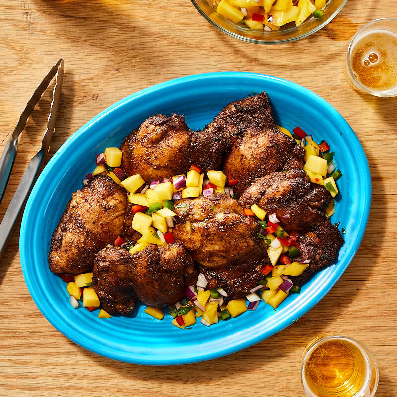 Jerk chicken thighs with fresh mango salsa by Millie Peartree