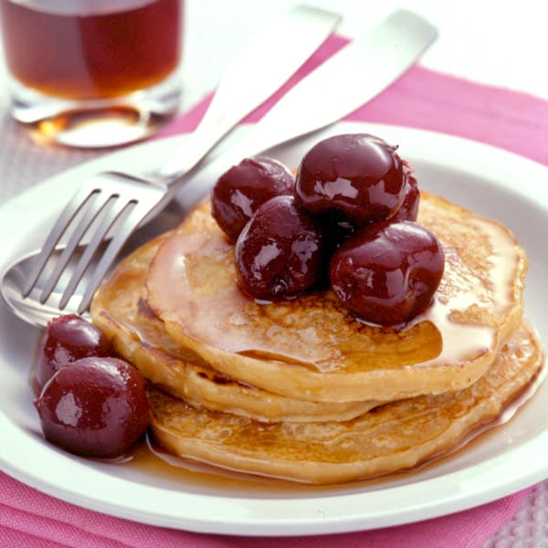 Photo of Oatmeal-buttermilk pancakes topped with cherries by WW