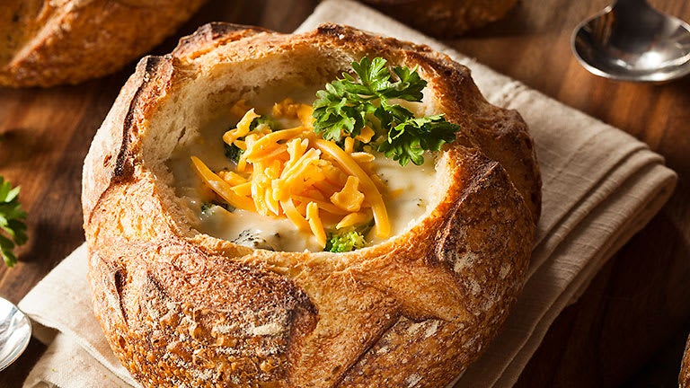 Creamy broccoli cheddar soup in a bread bowl