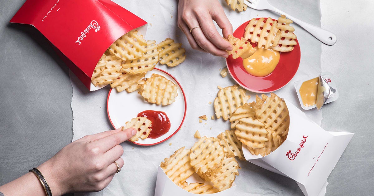 Waffle fries with ketchup and dipping sauce