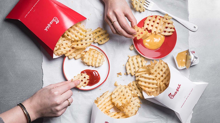 Waffle fries with ketchup and dipping sauce