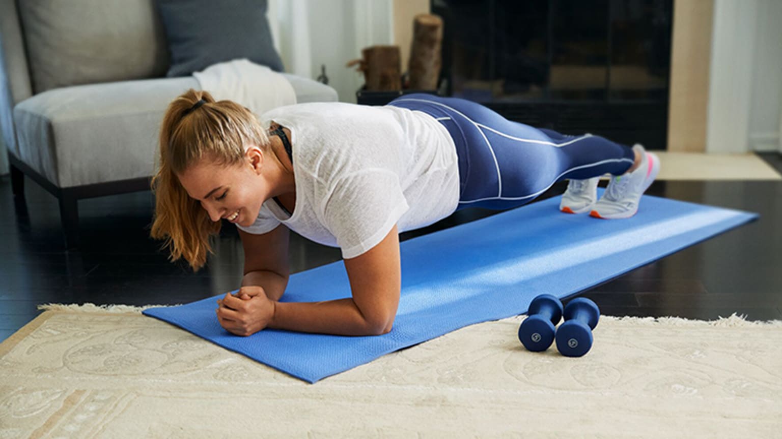 Amanda, membre  WW, fait une planche sur un tapis de yoga.