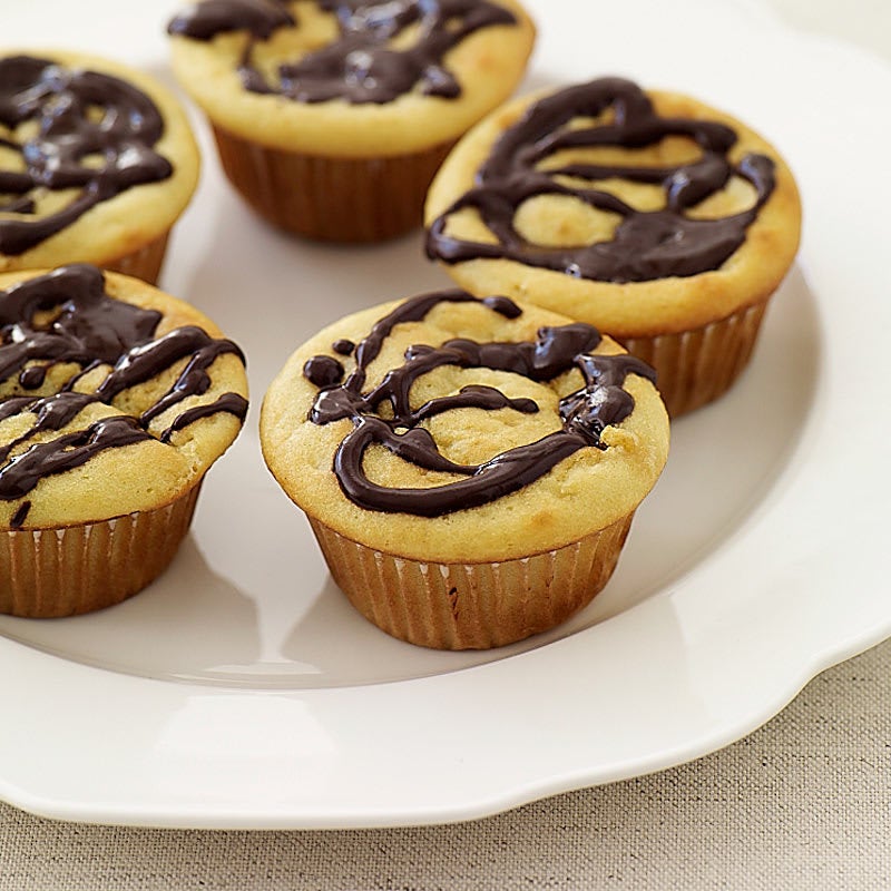 Photo of Vanilla cupcakes drizzled with chocolate by WW