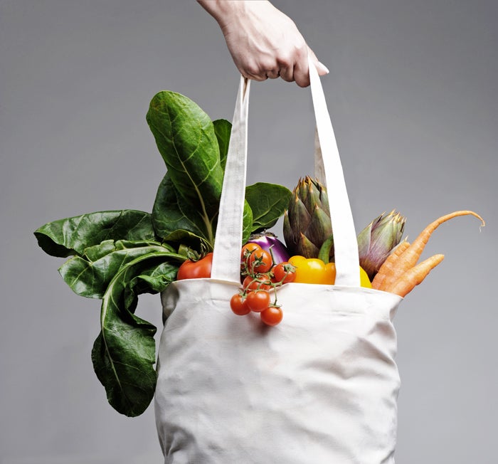 Cotton shopping bag overflowing with vegetables