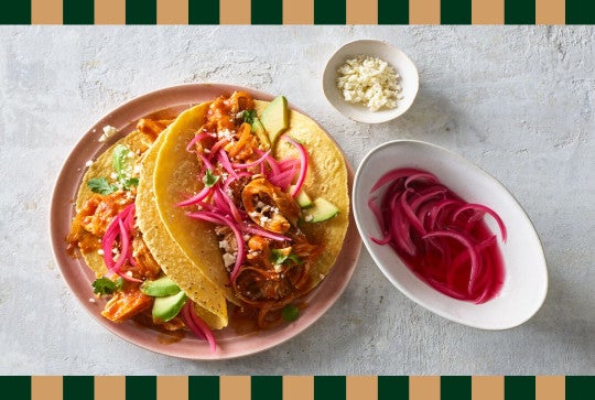 chicken tinga tacos with pickled red onions on the side
